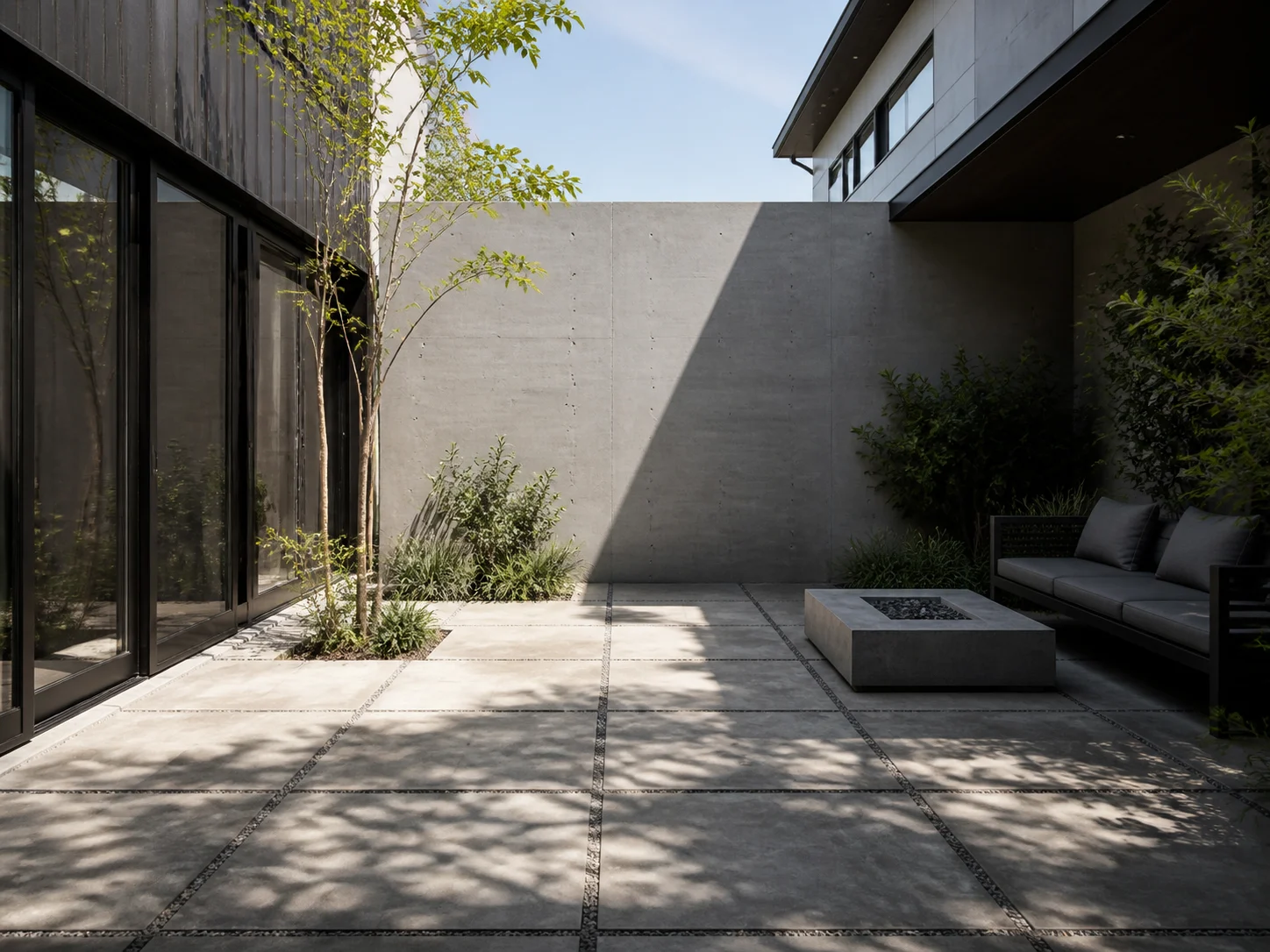 Modern enclosed courtyard with minimal planting and concrete pavers