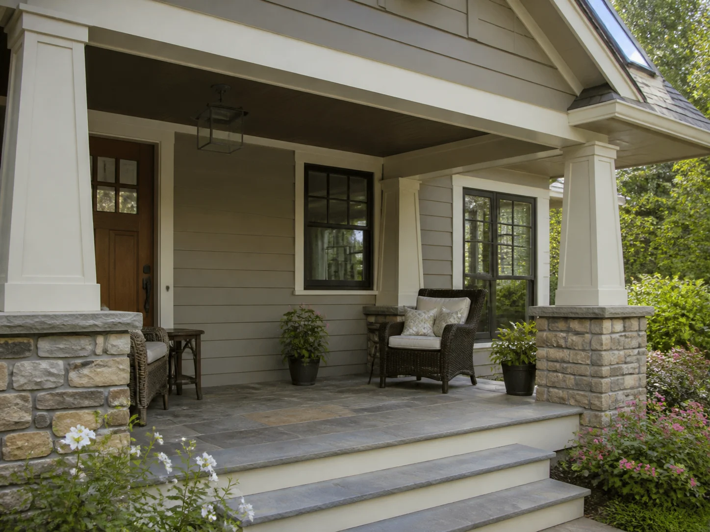 Craftsman front porch with tapered columns on stone piers