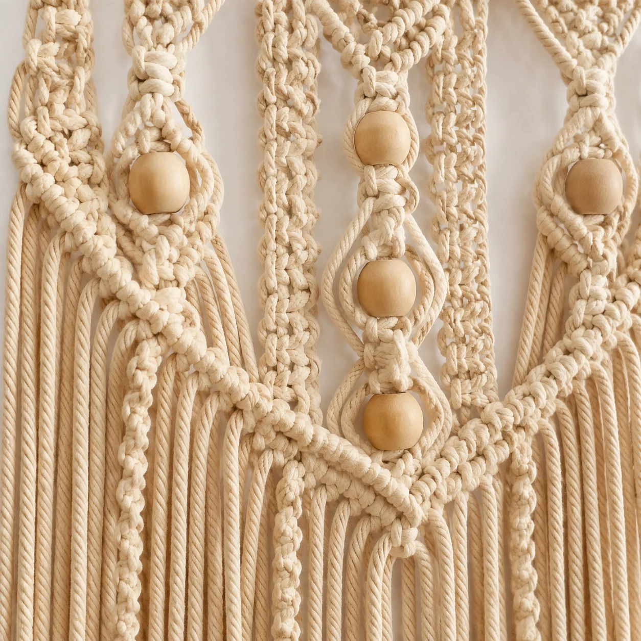 Intricate cotton macramé knotting with wooden beads