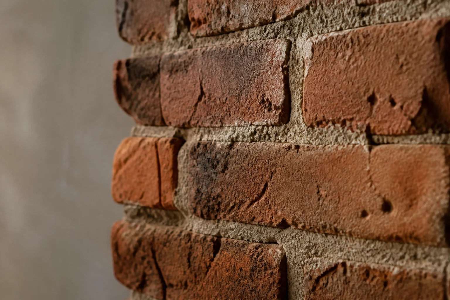 Close up of weathered red exposed brick.