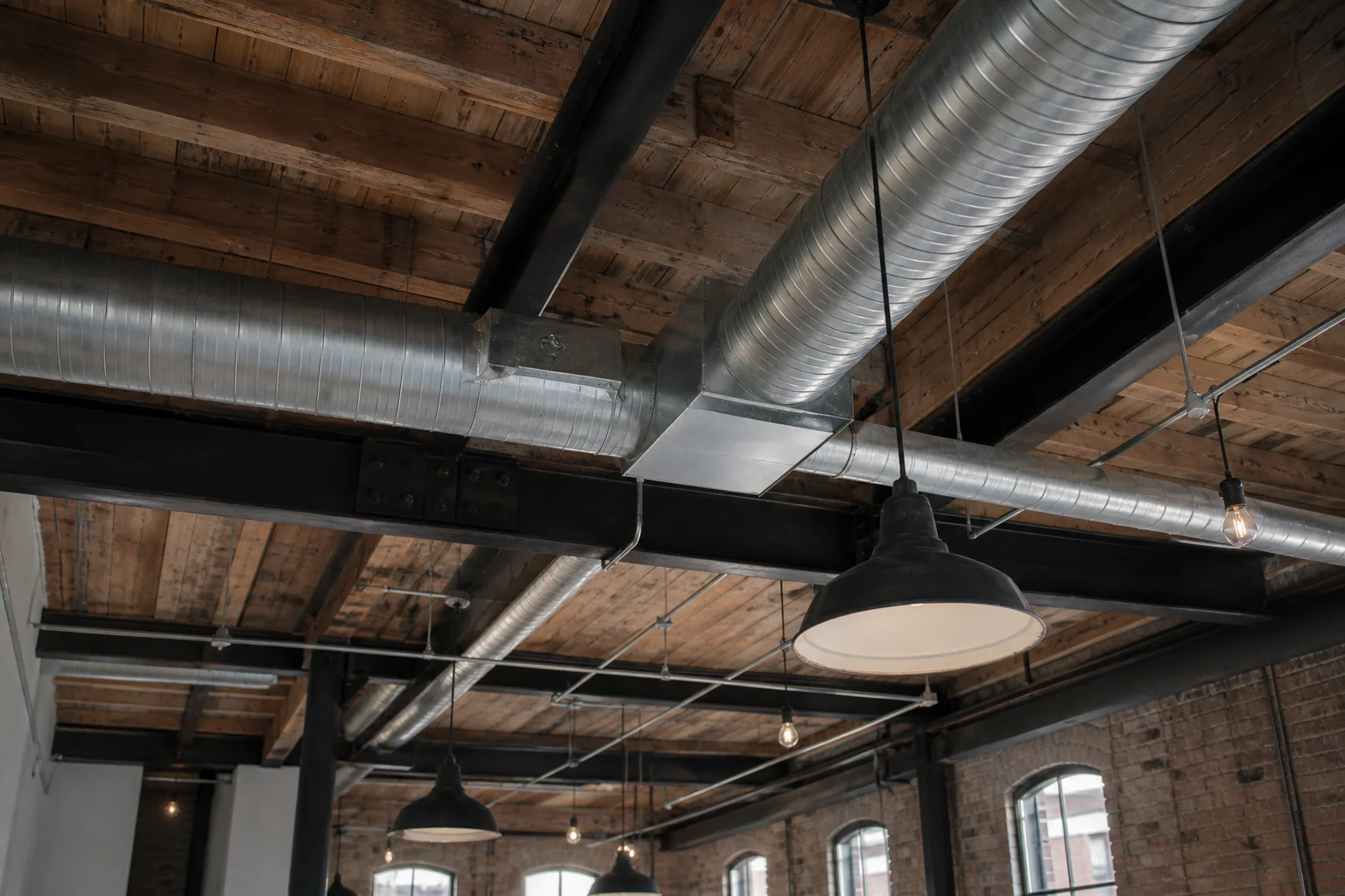 Exposed ceiling ductwork and steel beams in an industrial loft