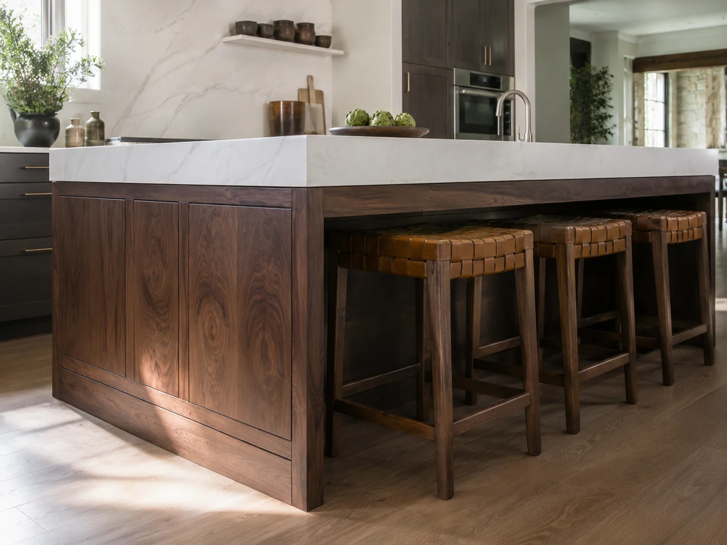 A large kitchen island featuring a contrasting dark wood base and a bright quartz countertop